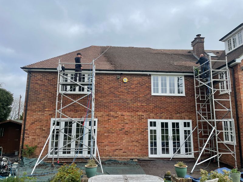 Roof cleaning carried out safely from scaffold towers by The Roof Moss Cleaners in Leatherhead